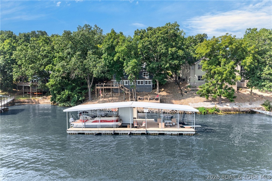 This updated lakefront home has been meticulously maintained and enjoyed by the current owners for over a decade. It offers rare lake frontage in a large, sought-after Buck Creek cove with deep water and main channel views. You get a three car garage, plus additional parking in driveway, plenty of outdoor living space, and a grandfathered martini deck, with gentle access down to the water.

There is a large dock envelope if you want to add on, and the current dock is already set up for year-round fishing and entertaining. Inside are three conforming bedrooms and two fully renovated bathrooms, plus two additional nonconforming bedrooms. That layout works well for full time living, a large family, or a short-term rental.

The inspection is already complete, the home comes with a one year home warranty, and it is selling fully furnished, so you can start enjoying the lake right away.

Located at the 8 Mile Marker, you have easy access to dozens of lakefront restaurants, bars, and entertainment.