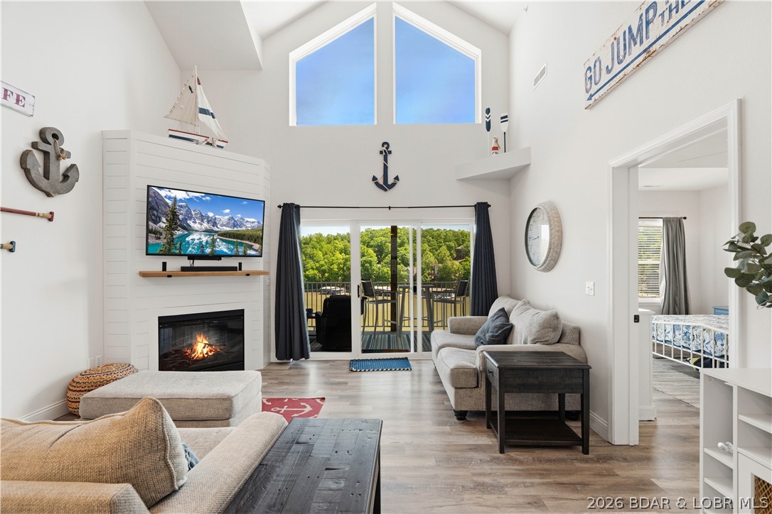 This is the kind of lake condo people wait for—top-floor views, beautifully updated, completely turn-key, and ready for you to enjoy from day one. Nightly rentals are allowed, and the boat lift is already in place for summer! This stunning 3-bedroom, 2-bath Loch Haven condo offers elevator access to the condo, lakeside pool, and dock, making lake weekends effortless. Inside, you'll find laminate flooring throughout the living room and bedrooms, quartz countertops, stainless refrigerator, microwave and dishwasher, freshly painted kitchen and bath cabinets, updated hardware, ceiling fans, new toilets, storm door, and a gorgeous shiplap fireplace with a new mantle. Sold fully furnished, it's perfect as a personal retreat or income-producing investment. Unwind on the screened deck overlooking the lake, then head out from your included 12x36 boat slip with added decking and dock box. Just minutes from Ha Ha Tonka, golf, Camdenton, and popular waterfront restaurants including Fish & Company, Larry's on the Lake, Nauti Fish Rum Bar, and Captain Ron's. This is lake living at its absolute best.