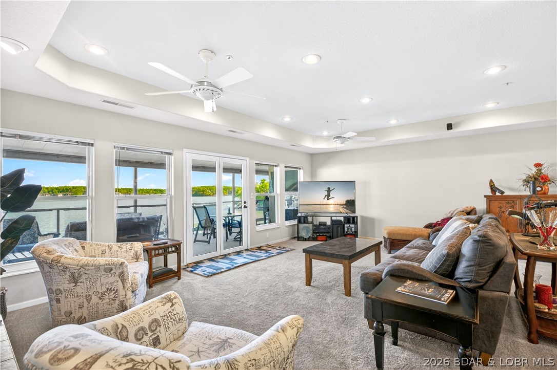 16x44 DOCK SLIP + PWC SLIP + FURNISHED + 2283 SQ.FT. + TOP-FLOOR UNIT= PERFECTION! Lakefront living with arguably one of the BEST VIEWS in Emerald Bay. This 4-bedroom, 4-bath condo offers a well-designed layout with the living area extending directly to a covered lakeside deck that captures wide open view of the 14 Mile Marker. Tray ceilings, a see-through fireplace, and a furnished interior add comfort and style throughout. The open floor plan showcases the view from the main living space, complimented by a spacious kitchen with pantry, great cabinetry, bar seating, and a designated dining area. Bedrooms are nicely sized and thoughtfully spaced, with 3 of the 4 offering en suite baths for added privacy. A utility closet and separate laundry closet complete the interior. The dock is a standout, featuring an oversized 16x44 slip—one of the largest available—positioned right next to the included PWC slip for easy, all-day lake access. Emerald Bay amenities include a community pool, clubhouse, tennis and pickleball courts, designated pet areas, breakwater dock system and more, making this an ideal full-time residence or lake getaway.