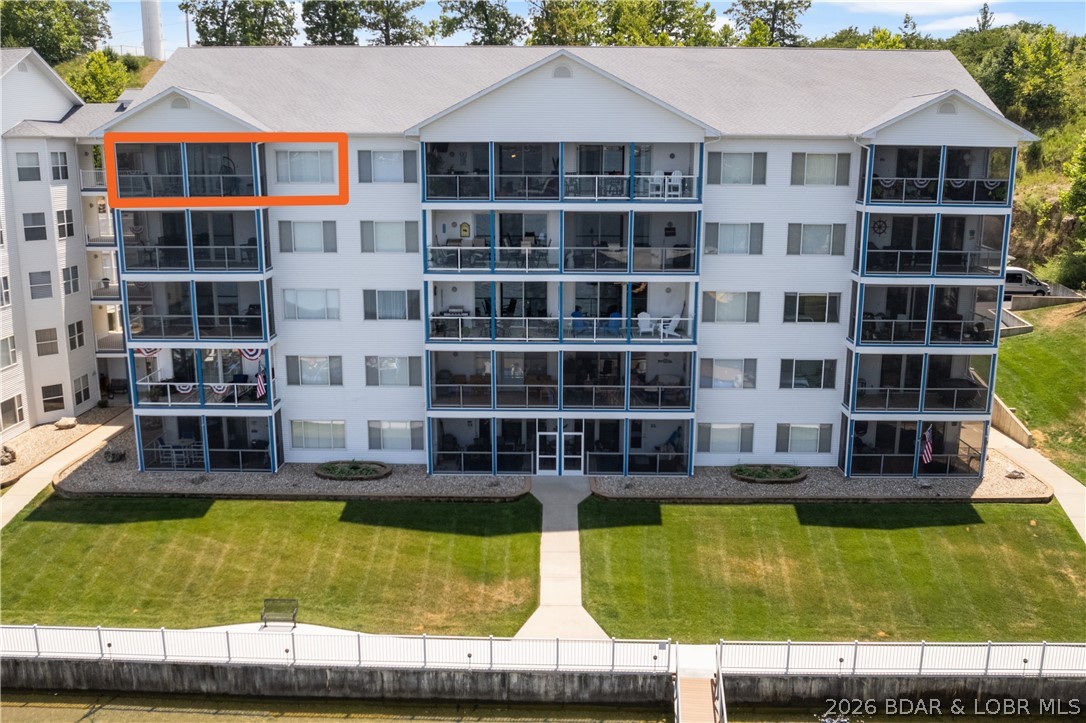 UNBELIEVABLE! One word describes this TRULY AWESOME unit's VIEW and Complex Amenities! This Penthouse Unit has Beautiful Cabinetry, LVP Flooring, Carpeting and Newer Paint! A Large Tiled & Screened Deck is great to enjoy the Amazing View! Located at the beginning of the Gravois Arm at Lake of the Ozarks, nestled in a quiet, deeper cove area that has easy access to restaurants, gas docks and the main channel. 2 swimming pools (1 fresh, 1 saltwater) 2 dedicated swim platforms (1 with kayak launch), an exercise facility, fenced playground (with basketball & pickleball courts), and some of the best fishing at the lake will surely keep your family and guests entertained! Unit includes a 12 x 32 slip in a well lit and maintained dock equipped with features such as water, electric, security cameras and fish cleaning stations. This complex is meticulously manicured and pet friendly! The boardwalk is great for evening strolls and enjoying the lake views! Friendly neighbors and events are just some of the reasons that make Blue Anchor Bay one of the most sought after condominium destinations at Wonderful Lake of the Ozarks! Located within Minutes of Great Restaurants & Entertainment by Boat!