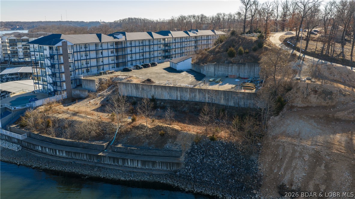 Exceptional lakefront development property located down Horseshoe Bend at the coveted 2 Mile Marker on Lake of the Ozarks. This incredible tract features 5-acres and 599 feet of Lakefront w/ deep water and cove protection, yet has huge views, an ideal combination for high-demand waterfront living. The site is well positioned for development with water, sewer, and electric already to the property. Most of the lakefront excavation has been completed, including concrete seawall and retaining wall providing a significant head start and reducing development costs. The property allows for approximately 27 boat slips (12x32), adding strong value and long-term appeal. Property is zoned R-3 and the density allows approx. 75 units, offering flexibility for condominiums, townhomes, single-family homes, or a mixed-use development. Developers may choose to sell individual lots or build and develop the project themselves. With a prime location, existing infrastructure, protected water, and commanding lake views, this is a rare and versatile development opportunity in one of the most desirable areas on Lake of the Ozarks.