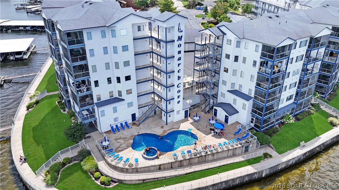 Gorgeous walk in level unit located at Lake of the Ozarks in the highly coveted Monarch Cove Condominiums. This unit will come fully furnished, turnkey ready for you to enjoy the Lake Ozark vibes. Featuring 9 ft ceilings, easy care wood, tile floors, fresh paint and updates throughout. The unit is a walk in level with no steps from parking lot to door. As you head in the living, kitchen and dining room are open concept and head out to the Lakeside patio to take in the views!! Master bedroom suite is also located lakeside with a spacious full bathroom and walk in closet. The guest bedroom is located on the roadside of the unit, along with full bath. The unit will come with a 12x32 slip in a protected dock. The complex also features elevators, heated pools, hot tubs, outdoor grill areas and much more. A boardwalk that wraps around the Lakeside with beautiful landscaping and Lake Ozark views. Monarch Cove is one of the most coveted locations as it is at the beginning of Horseshoe bend, minutes from Bagnell Dam strip, shopping, dining and night life. Monarch allows for nightly rentals for those looking for an investment opportunity. Call to day to schedule your private tour.