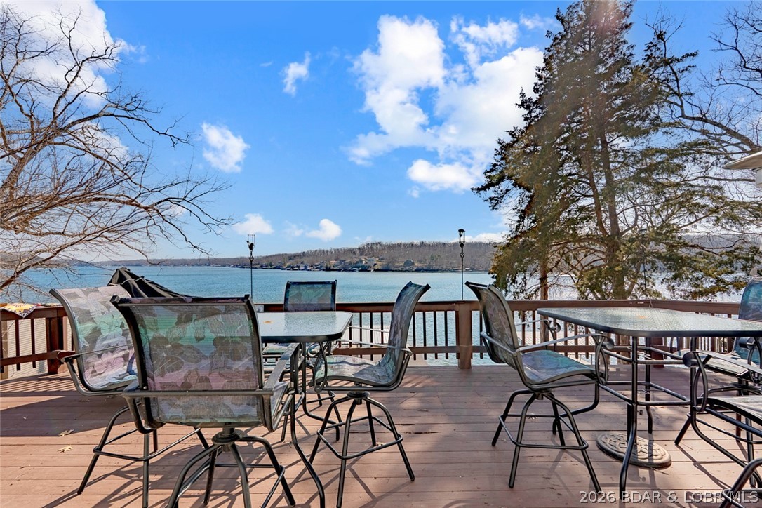 Tucked along the shoreline in year-round deep water, this lakefront cabin is the kind of place families buy to make memories for years to come. From mornings on the screened porch to afternoons on the dock and evenings on the oversized lakeside deck, this home was built for enjoying the lake lifestyle.

The home offers 3 bedrooms, 2 bathrooms, plus additional BONUS ROOM heated and cooled sleeping space for extra guests. The bonus room has a futon and an extra beer fridge! Major updates have already been completed, including granite counters, paint, and flooring.  NEW WELL PUMP AND BRAND NEW SEPTIC , and the home comes furnished so you can start enjoying it immediately.

The easy walk to the 2-well dock with swim platform, hoist, and storage makes lake days effortless. Located in deep water with a protected feel, this setup is hard to find at this price point. Rentals are allowed, giving flexibility for full-time living, weekend use, or investment potential. By water, you’re close to Jolly Rogers, Coconuts, and Tap & Grill while still feeling tucked away in your own private lake retreat. Room to add more parking or a garage in needed. Its your OWN VERY LAKE CABIN, CALL TODAY!