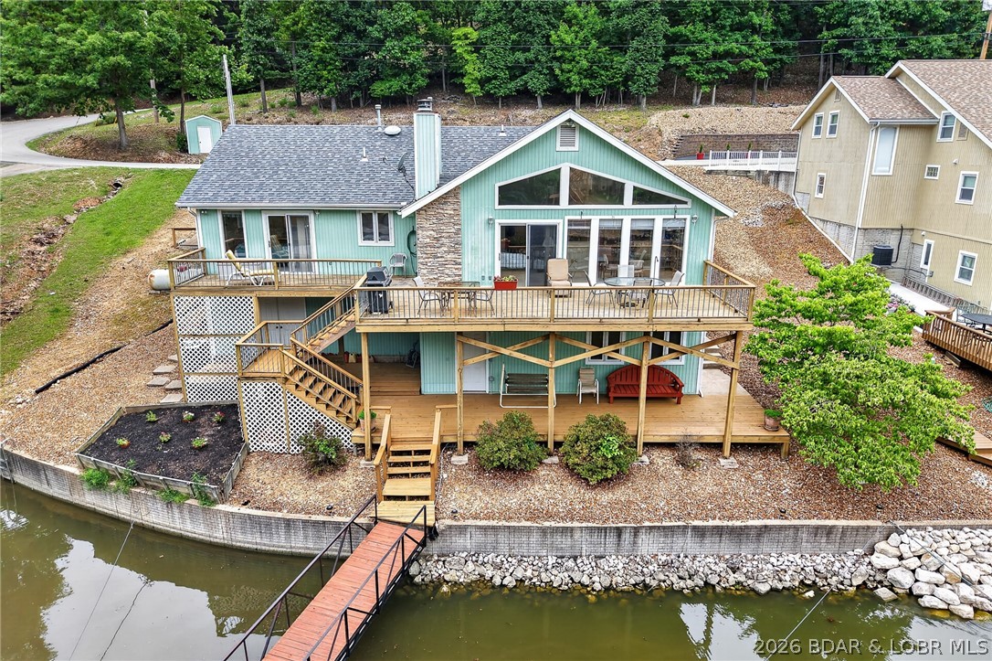 This property offers calm waters, 3 to 4 bedrooms, 3 full baths, an office, and spacious areas for living, dining, and entertaining. The home at 268 Murray Hill has been meticulously maintained for 26 years and is ready for its next owners. The main floor features an open-concept layout with vaulted ceilings, a bonus room or office near the entry, 3 bedrooms, 2 baths, a kitchen with a Butler’s area, laundry, and a living room with stone fireplace, with a wall of windows opening to a large deck overlooking the water. The lower level includes a fourth bedroom with bath or a game room, office, or craft room, a workshop with workbenches, and ample storage for lake equipment. Additional amenities include parking for 6–9 vehicles (driveway and 2nd tier lot for additional private parking) a gentle walk to the dock with 4 feet of water in winter (10 ft at full pool), a 2-well dock (10 x 28 & 10 x 18) with swim platform and wet steps, and 2 lifts, convenient access to the subdivision boat ramp and trailer parking. All furniture, appliances, and contents are included. This little beauty can be yours to update as you will or just enjoy, enjoy!!!