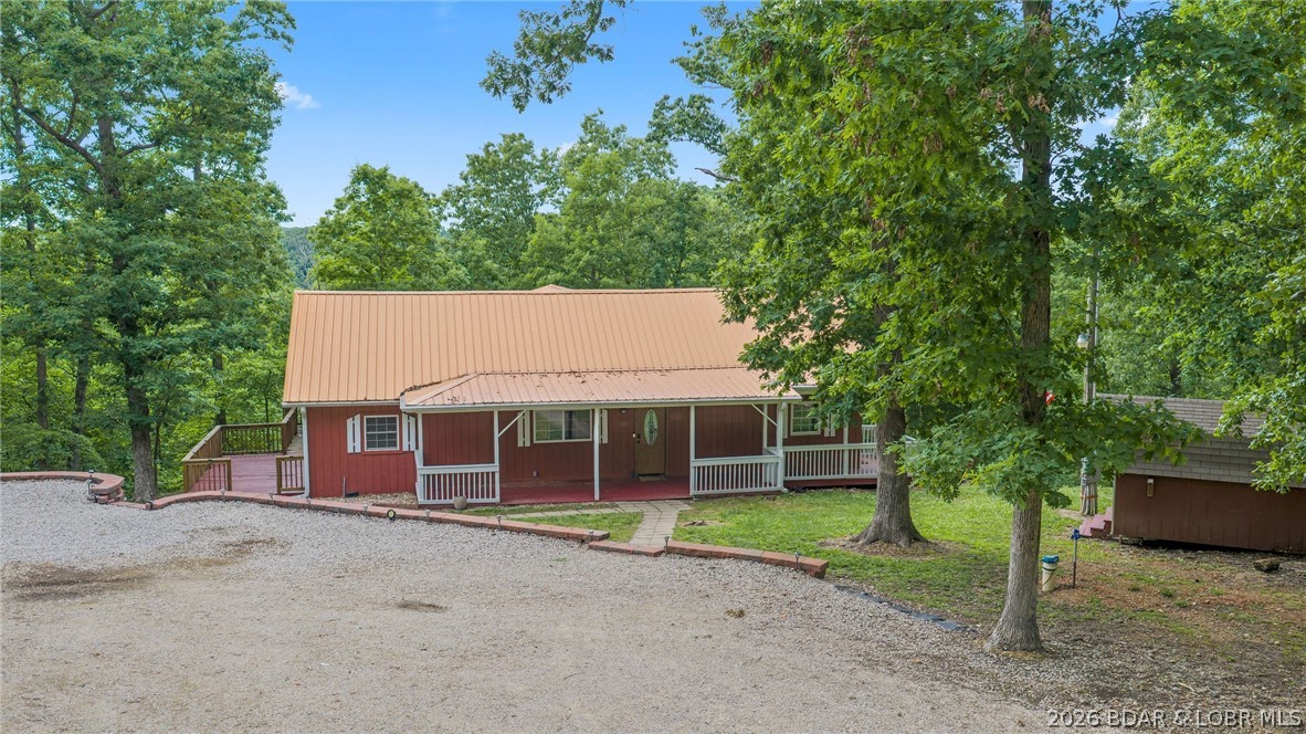 If you're looking for peace, privacy, and room to roam, this incredible property delivers. Situated on 17+ acres near the 55 mile marker of Lake of the Ozarks and less than 2.5 miles from Ozark International Raceway, this property offers the perfect blend of seclusion and convenience. The 1,600 sq ft home features 3 bedrooms and 2 full baths, with a shaded deck complete with retractable screens--perfect for enjoying the outdoors year-round. Unwind in the jetted hot tub while taking in the quiet country setting. For those needing workspace or storage, the 30x50 heated and cooled shop is a mechanic's dream. The property also includes a separate mother-in-law suite with a full bath and a 3-car garage with openers. The land itself is just as impressive, offering two wells--one at the home and another on the acreage, ideal for a future RV site or hunting cabin. Whether you enjoy hunting, riding side-by-sides, or simply soaking in the outdoors, this property is set up for it all. Quiet country living with space to live, work, and play--this one checks all the boxes.