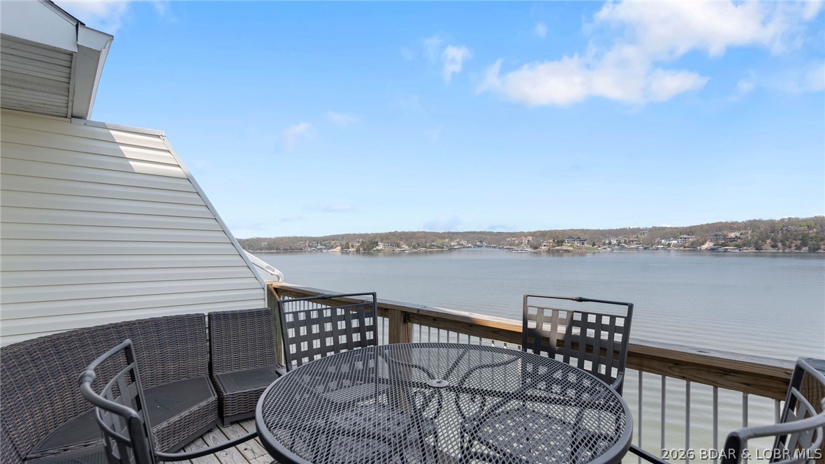 Welcome to this beautiful top-floor, turnkey condo in the heart of Osage Beach! This updated unit offers stunning views of the 21 MM of Lake of the Ozarks. Inside, you’ll find updated appliances and newer furnishings, making this property truly move-in ready. Whether you're looking for a personal weekend getaway or a smart investment, this unit is approved for nightly rentals—offering excellent income potential. The spacious two-story living room features soaring vaulted ceilings, an abundance of natural light, and direct access to the private deck—perfect for enjoying those incredible lake views. The primary suite includes an ensuite bath with double vanities for added comfort and convenience. Upstairs, the loft overlooks the main living area and serves as a second living space, also showcasing beautiful views of the lake. This property includes a 10x30 boat slip and access to fantastic community amenities such as a sandy beach, 2 community pools, and a  playground—all within a short-term rental-friendly complex. Don’t miss this opportunity to own a piece of lake life at its finest! Call for a private showing today!