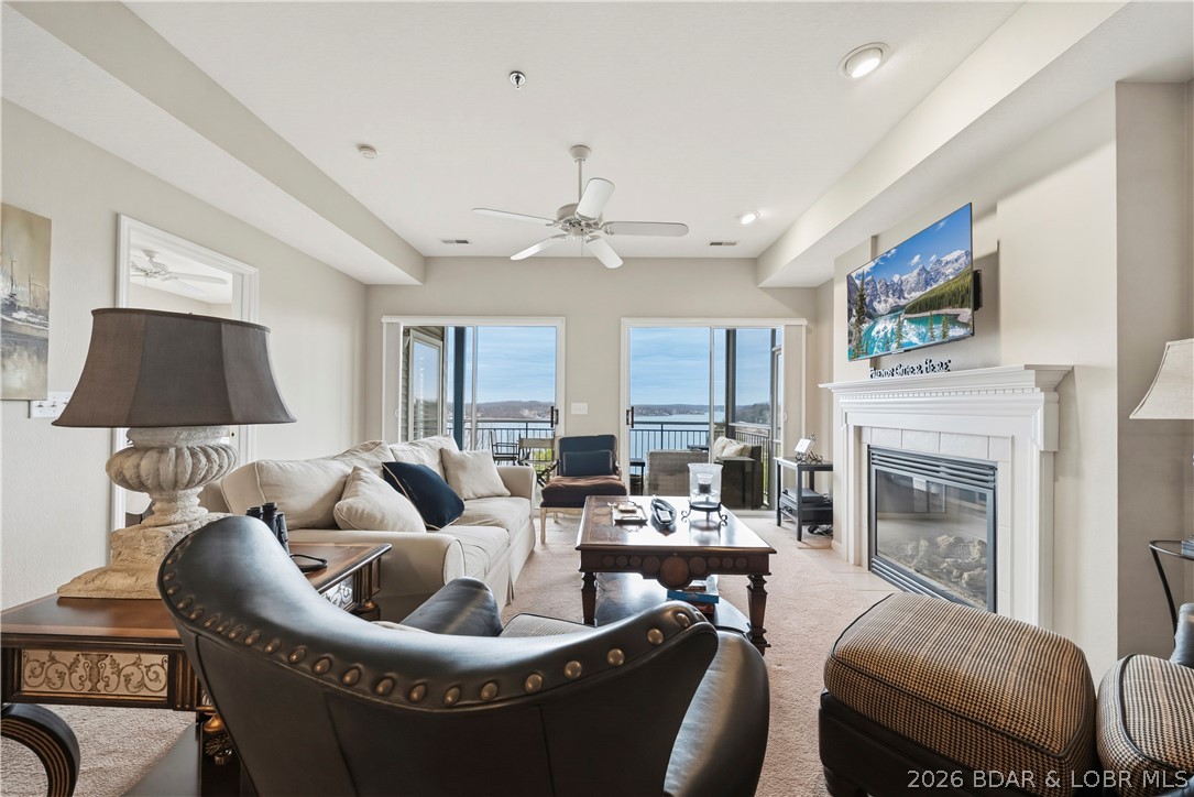 Amazing main channel views from this condo at Palisades! Welcome to your cozy lake getaway. This move-in ready, beautifully maintained 3 bedroom, 2 bathroom condo comes furnished and includes your own boat slip with a 10,000lb lift. You will love the open layout with a bright, modern feel, LVP flooring and gas fireplace. Master bedroom has walk in closet, double vanities, and sweet plantation shutters on the windows. Kitchen has nice bright white cabinets and stainless-steel appliances. Plus, HVAC and water heater are newer, so no worries there. Relax and take the views from your screened-in, covered deck, perfect for enjoying the lake year-round. Complex features 3 pools, clubhouse, and gated entrance. Ideally located on the 14MM where you are in a prime spot to experience everything the lake has to offer.  Perfect as a personal retreat or would make a great investment property!