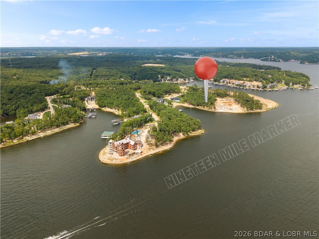Every exceptional lake home starts with an exceptional homesite, and Lot 471 at The Nineteen delivers one of the finest opportunities available at Lake of the Ozarks. Situated on the coveted 19 Mile Marker, this premier waterfront lot offers approximately 0.93 acres and an impressive 183 feet of lake frontage in one of the lake's newest luxury communities. Enjoy the rare combination of a cove-protected setting for calmer water, swimming, and dock enjoyment, while taking in breathtaking panoramic main channel views. The seawall is already in place, providing a head start on building your dream lakefront retreat, and custom building plans are available upon request. Surrounded by stunning luxury homes and exceptional architecture, this property offers the perfect canvas to create a one-of-a-kind estate. Conveniently located by both land and water, you'll be just minutes from many of Lake of the Ozarks' premier restaurants, shopping, golf courses, entertainment, and waterfront attractions. Opportunities like this are increasingly rare—Lot 471 represents one of the premier lakefront homesites on the market today and is ready for your vision to become reality.