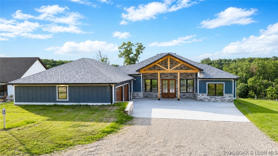 Experience lake living with sweeping views of the 5MM from this stunning 4 bed, 2.5 bath custom Amish-built home situated on a desirable 2nd-tier lot. Paved roads lead to the new development, Los Breezes, where buyers have the rare opportunity to get in on the ground floor of a new HOA offering community well water. Enter from the covered front porch with 8x8 posts through glass, double front door to soaring vaulted ceilings where wall-to-wall windows frame breathtaking water views. The open concept floorpan leads to a chef's Kitchen w/ solid Hickory wood cabinets, quartz countertops, black stainless appliances, large island & a spacious walk-in pantry. The living area features stone fireplace that flows seamlessly to a massive covered deck, perfect for entertaining friends & families while taking in the sounds of the water beyond. An oversized 2-car garage offers plenty of room for ATVs, golf carts, or motorcycles, while the mudroom with cabinets & bench keep coats and boots organized year-round. Quality craftsmanship shines throughout with Smart Siding, LVP flooring & 6 inch trim. Newly seeded with straw, the landscaping & garden possibilities are endless!