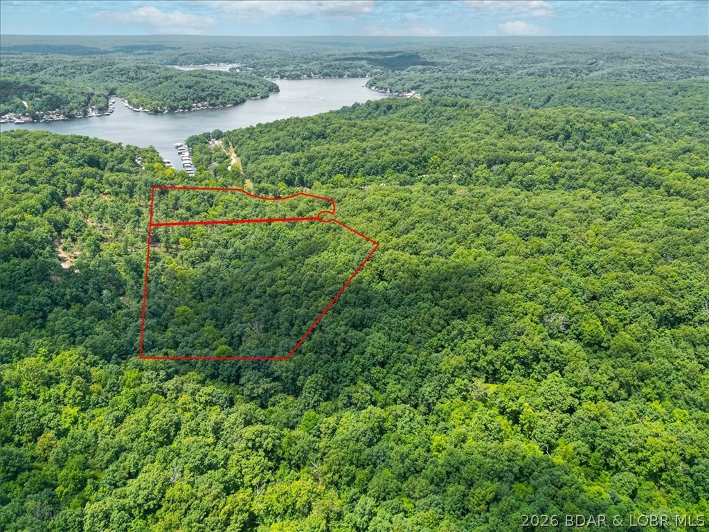 Experience the perfect blend of nature and opportunity with this 22.77-acre property, just 15 minutes from the Coffman Beach Public Boat Launch and the stunning Lake of the Ozarks! Recently cleared paths invite you to explore or plan your dream build, with multiple scenic sites ready for your custom home or retreat. With no restrictions, you have the freedom to bring your vision to life. Whether you're a nature enthusiast, a hunter, or simply seeking a peaceful escape, this land is a haven for wildlife, where deer and other native species roam freely. Don't miss this rare chance to own a slice of paradise near one of Missouri’s top recreational spots. Contact us today to schedule a tour and unlock the potential of this remarkable property!