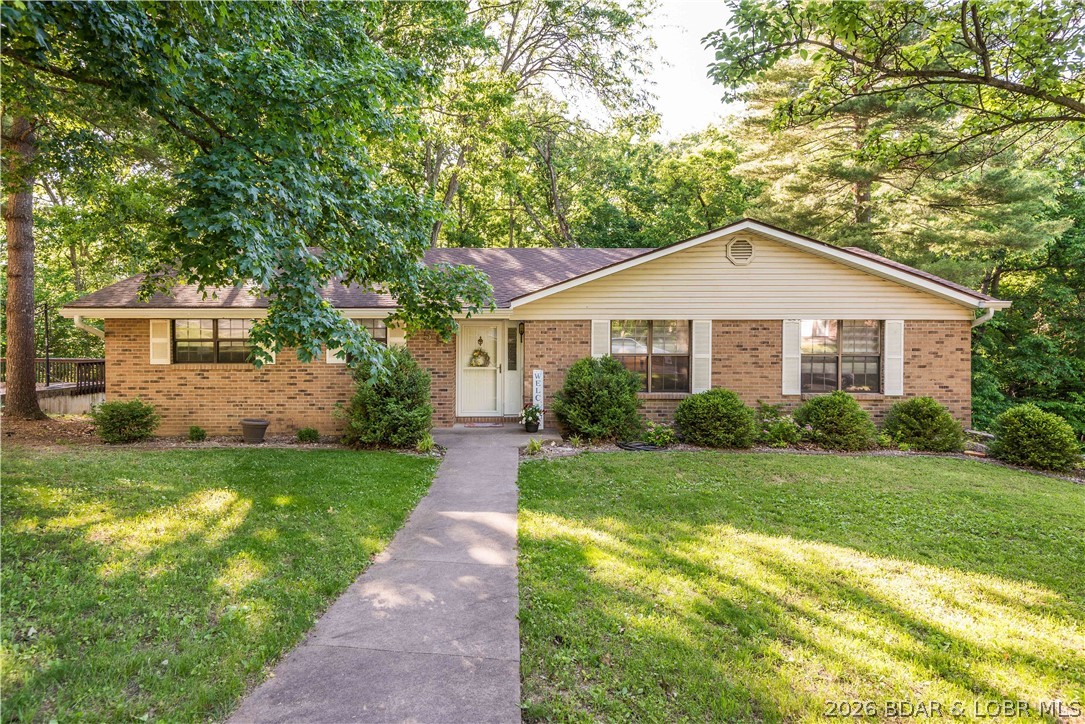 Wonderful brick ranch home in great west-end location on a beautiful 1/2 acre wooded lot. The well-maintained home has hardwood floors on much of the main level, a light-filled living room, formal dining area w/antique brass chandelier, & an updated kitchen w/granite countertops, soft-close cabinetry, white subway tile backsplash, pantry, & all appliances convey. Kitchen and breakfast area open to a cozy family room w/sliding glass doors leading to a large composite-style deck overlooking a peaceful backyard. Main level offers a spacious primary suite w/walk-in closet & private bath, plus two additional bedrooms & an updated hall bath. Finished lower level has a huge family/rec room w/LVT floors, built-ins, half bath, & a brick WB fireplace. Super home on large lot in great neighborhood!