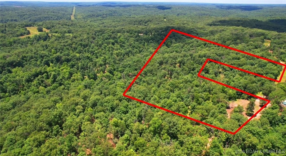 Are you looking for a private location to build your dream home, a weekend retreat, or the perfect spot to hunt and explore? This is it! This exceptional 34± acre property is tucked away in the heart of Morgan County and offers the ideal blend of privacy, recreation, and convenience. The land features several beautiful building sites, established trails, wet-weather creeks, and abundant wildlife—making it perfect for outdoor enthusiasts. And for those who crave adventure, you’re just a short drive from a popular ATV parks, with the ability to hop on your ATV and hit the trails! Whether you’re seeking adrenaline-filled weekends or a peaceful escape from it all, this property delivers. Electric is already available at the corner of the property, making it even more attractive for building. Bonus opportunity: the home located across the street is also available for purchase, offering endless possibilities for a full-time residence or investment. Ready for your next adventure? This is it! Owner Financing Available.