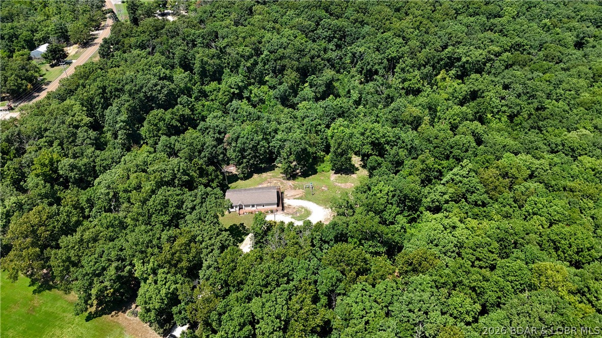 Welcome to 11 Kristy Road, Eldon, MO, where peaceful country living meets convenience! This spacious 5-bedroom, 3-bath home sits on 7.7 private acres filled with wildlife and natural beauty. The main level offers three bedrooms, two baths, a bright living room, separate dining area, and a large open kitchen perfect for gathering. The primary suite features a spacious private bath with a soaking tub and walk-in shower. The fully finished walkout basement includes two additional bedrooms, a full bath, a large family room, and access to the attached two-car garage. Enjoy morning coffee on the deck or unwind on the covered patio while taking in the peaceful surroundings. Area to build a shop with a second septic and well in place. Located in the highly sought-after School of the Osage School District—recognized for its strong academics, outstanding extracurricular programs, and community prideJust a short drive from the Lake of the Ozarks, you'll have easy access to boating, fishing, golf, dining, shopping, and year-round recreation. Experience the perfect blend of privacy, acreage, excellent schools, and nearby lake living. Schedule your private showing today!