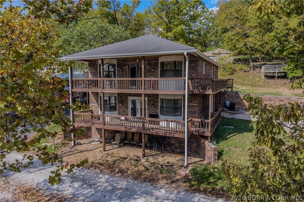 Discover your dream lake retreat on the 77-mile marker of Lake of the Ozarks! This all-brick two-story home sits on nearly a half-acre lot with year-round water views and a private dock featuring one well and a party space that can easily convert back to a two-well slip. The main floor has been fully renovated with a spacious kitchen, open living area, primary suite, second bedroom, and two full baths. The lower level offers additional living space, a large bedroom, and flex area that can be used as you wish. Enjoy decks on both levels, all-new paint, fixtures, flooring, cabinets, and appliances-95% remodeled and move-in ready. Easy commute from Kansas City makes this the perfect weekend escape or full-time lake home! Bonus: the adjoining property next door is also for sale ideal for owning two homes side by side for vacation rentals or a family compound.