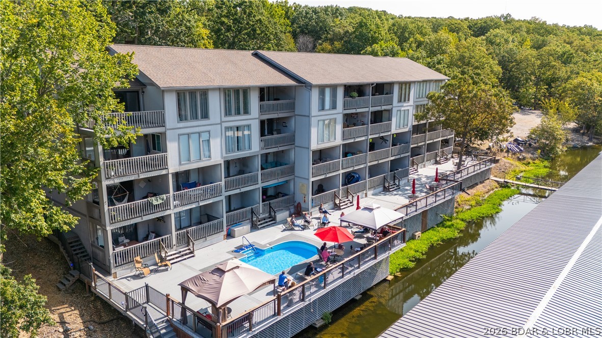 Welcome to this turn-key 2-bedroom, 2-bath lakefront condo at Lake of the Ozarks, perfectly located in Osage Beach at the 17 Mile Marker. Tucked into the calm, no-wake waters of Pogue Hollow Cove, this waterfront condo with boat slip offers the ideal mix of convenience and peaceful lake living. The unit includes a 10x24 boat slip with a lift and features new windows and sliding glass doors, a valuable recent upgrade. What truly sets this property apart is the rare combination of amenities that are getting harder to find at the lake. Enjoy boat trailer parking and a private boat ramp, making lake access simple and stress-free. Eagle Bay is also a non-rental community, creating a quieter, more private atmosphere with several full time residents. Relax at the lakeside pool overlooking the cove, or head out by water just minutes to Red Heads, Dog Days, Backwater Jack’s, and Lake House 13. The quiet cove also has an on-water gas marina (MarineMax). Very low HOA dues include everything except electric! If you're looking for a Lake of the Ozarks condo with a boat slip in Osage Beach, this is a great opportunity to enjoy the lake the way it’s meant to be.