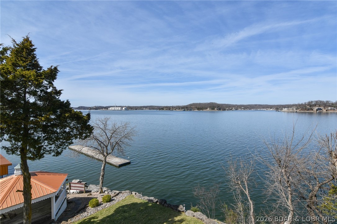 The Point Building #65 at Copper Ridge condominiums has the most incredible views. Fully furnished 2 bedroom and 2 bath condo is perfect for creating cherished lake memories. Walk down to the lake's edge to the famous gazebo!  What a great way to spend time watching the boat activity! THE BEAUTIFUL BRAND NEW BOAT DOCKS are amazing- Dock B slip 1 Left side (10'x28') is included and so close, you can see your boat. Newer roofs. Copper Ridge is conveniently close to town, too. Great by water at the 2 mile marker.  Boat down to the Dam or head up to Gravois Arm and cove out on you day off! The Bagnell Dam Stirp, Willmore Lodge, grocery stores, theaters, wonderful state parks are so close to explore. Smaller complex is quiet and cozy, nestled at the end of a small cove- professionally managed and lower assessments. Amenities include well-manicured grounds, lakeside promenade, and community pool. You will love living on the Point - THE VIEW IS SPECTACULAR!!!