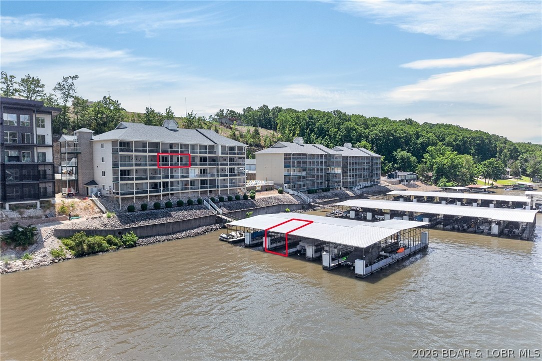Immaculate and move-in ready, this beautifully updated 2-bedroom, 2-bath condo offers effortless lake living just one level up from parking with convenient elevator access. Nestled in a quiet, cove-protected setting, the unit features stylish quartz countertops, refinished cabinetry, tile backsplash, stainless steel appliances, and a bright, open floor plan designed for comfort and entertaining. Enjoy relaxing mornings and evenings on the tiled, screened-in patio, or spend your days at the outdoor pool and on the water with your included 12x32 boat slip—perfect for boating, fishing, and swimming. Ideal as a full-time residence or private weekend retreat, this pristine condo delivers low-maintenance luxury in a highly desirable waterfront location.