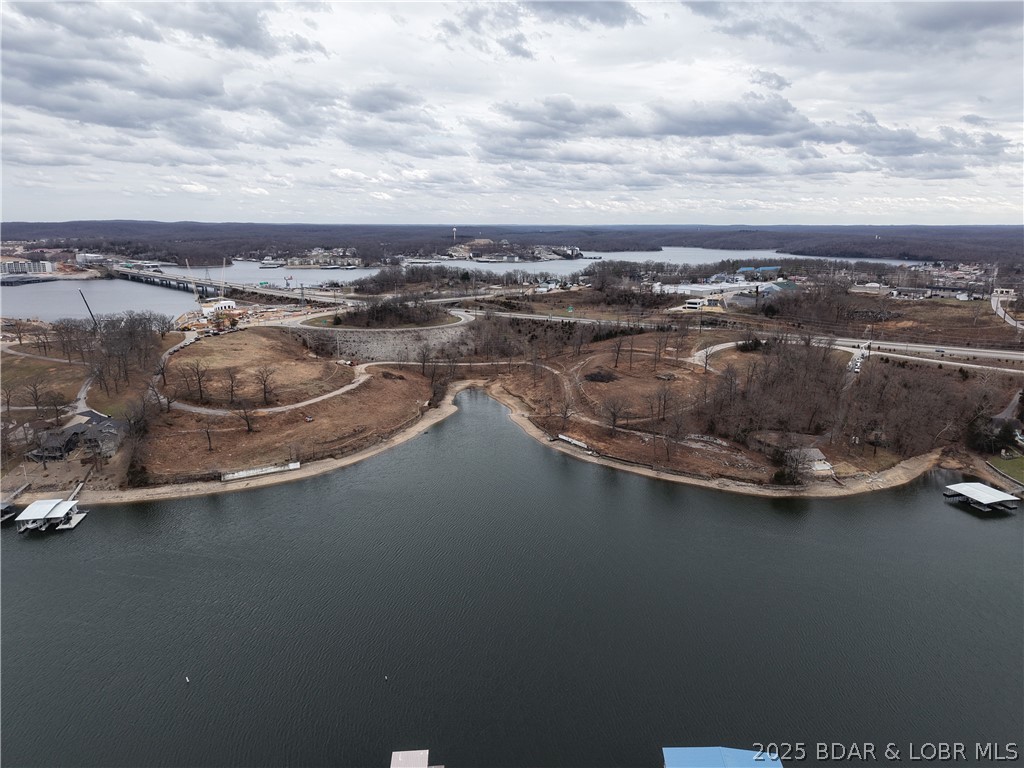 Exclusive Lake Ozark Waterfront Development Opportunity!! Experience one of the last great pieces of prime shoreline real estate on Lake of the Ozarks. 8.5 +/- acres of pristine waterfront, this property offers endless potential for a luxury resort, marina, or private estate enclave. Situated along prestigious Jeffries Street, these commercial and waterfront lots combine elite accessibility with breathtaking panoramic views. Highlights of property include: Gently sloping terrain ideal for luxury builds, exceptional water frontage and sunset exposure and rare large acre offering in the heart of Lake of Ozarks. All utilities nearby and easy highway access. Will divide.