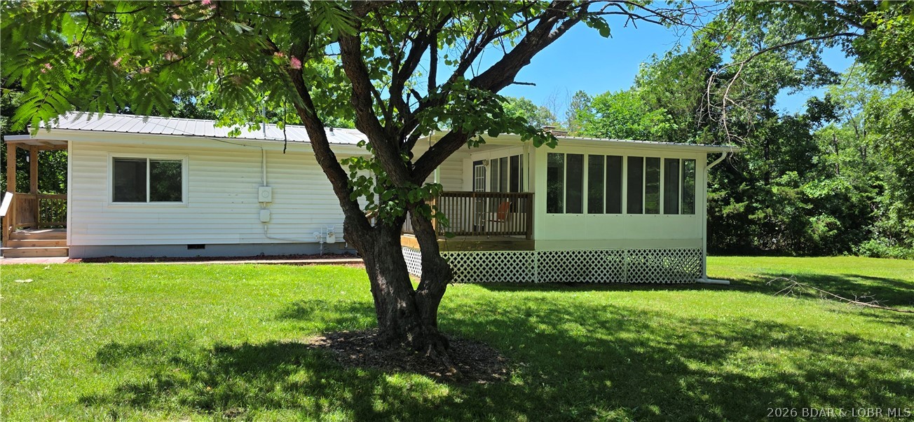Really nice country setting with access to Lake of the Ozarks. Move-IN ready with all the fresh updates including new paint, newer roof, new HVAC, new plumbing, bathroom, floors redone. This home sits on a level 1.5 acres with views all the way around. Room for a garden. Out standing 30 x 24 garage and concrete patio. There is a all season sun room attached to the home also. Wood burning fireplace for those cozy winter nights. Located within 10 minutes of Laurie or Gravois Mills and a short distance to Lake Burger. This is an inexpensive way to call this home YOURS.