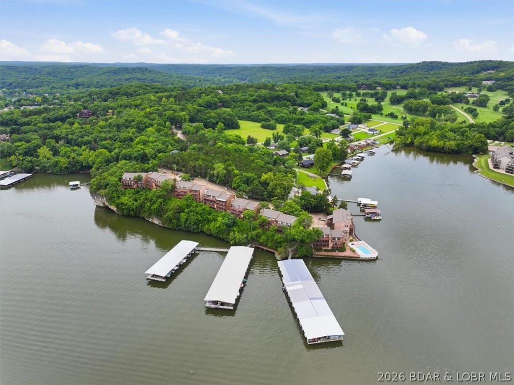 Welcome to your perfect lakeside escape! This beautifully maintained, turnkey lakefront condo offers 821 square feet and an incredible opportunity to enjoy affordable lake life. Nestled on the peaceful side of the Lake, you'll enjoy a quiet cove while just minutes from shopping, dining, and entertainment.  Take in breathtaking lake views from the spacious deck, features updated appliances, under-cabinet lighting, and comes furnished, making it ready for immediate enjoyment.  Rare bonus of TWO included boat slips with lifts and dock boxes, located in an area known for excellent fishing and calm waters, Don't miss this opportunity to own an affordable piece of lakefront paradise and start making memories at the Lake of the Ozarks today!