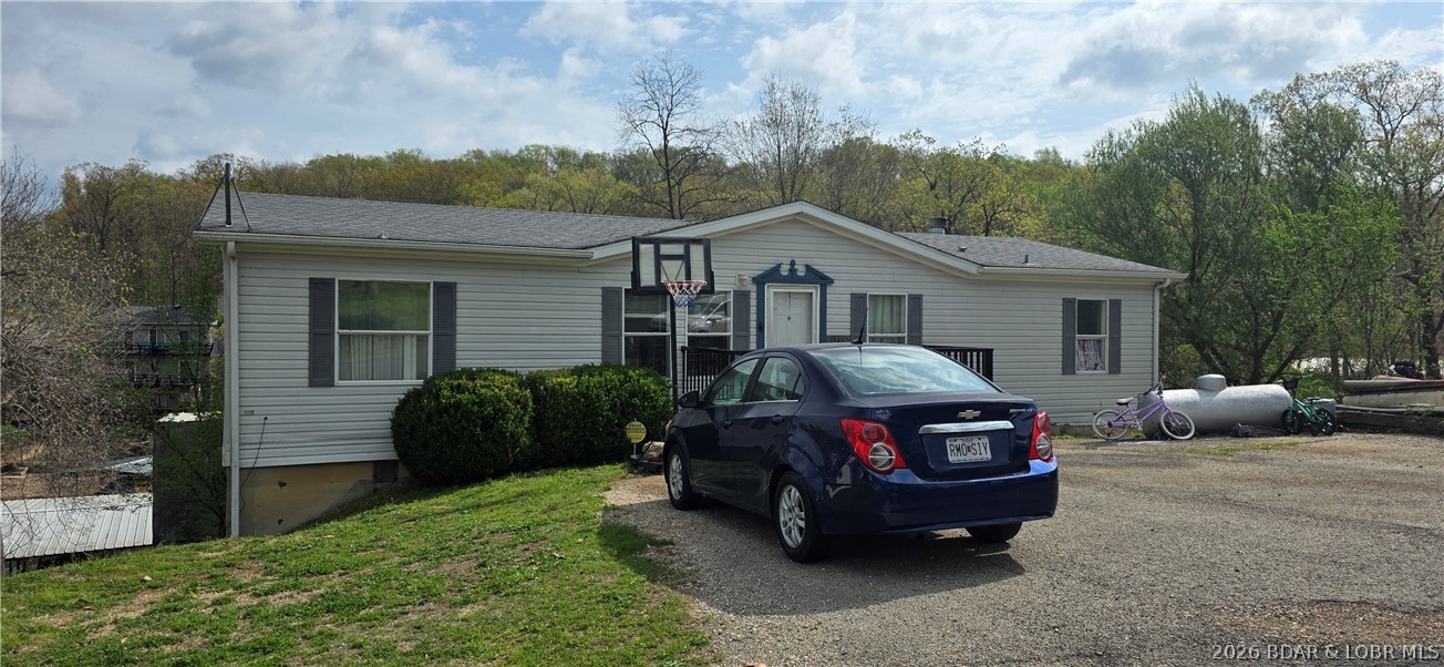 Large lakefront family home tucked back in a protective cove for swimming and floating.  5 bd 3 ba home with lots of sq. ft. for room for all your family and friends.  Spacious deck with trek decking for all your entertaining needs.  Great location by road or water at the 9 Mile Marker and close to shopping and Restaurants.  Finished basement with walk-out to your own private dock.  Blacktop to the door plus a newer septic system installed just a few years ago.   Come take a look, it's hard to find this much of a home square footage at this price level.