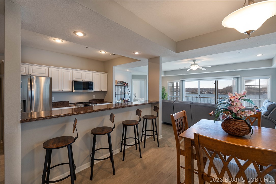 LAKEFRONT CONDO W/ BOAT SLIP! This 3BR/3BA end unit at Harbour Towne has endless lake and sunset views at the 2 mile marker at Lake of the Ozarks! It offers open concept living with over 1,500 sqft, 3 Bedrooms (2 ensuites) and 3 full baths. Updates include LG stainless appliances, Ruud hot water heater, electric fireplace, GE washer & dryer, A/C and LVP flooring throughout. Comes with 12x28 boat slip & dock locker-right in front of your condo. The expansive lake views from your screened in wrap-around patio are worth every penny! You will also fall in love with the amount of storage and the closet organizational systems throughout. Parking isn't an issue, as you get your very own assigned parking spot with plenty of overflow parking for guests as well! Plus, both garages are right outside the condo entrance and are the only adjoining garages at the complex. This makes an excellent choice for full-time, second home or investment opportunity with nightly rentals allowed! Close to Bagnell Dam Strip, local restaurants & shopping! Amenities include two heated swimming pools, club house, boat trailer parking, playground & tennis/pickleball court! TWO ADJOINING GARAGES AVAILABLE FOR $$$$!