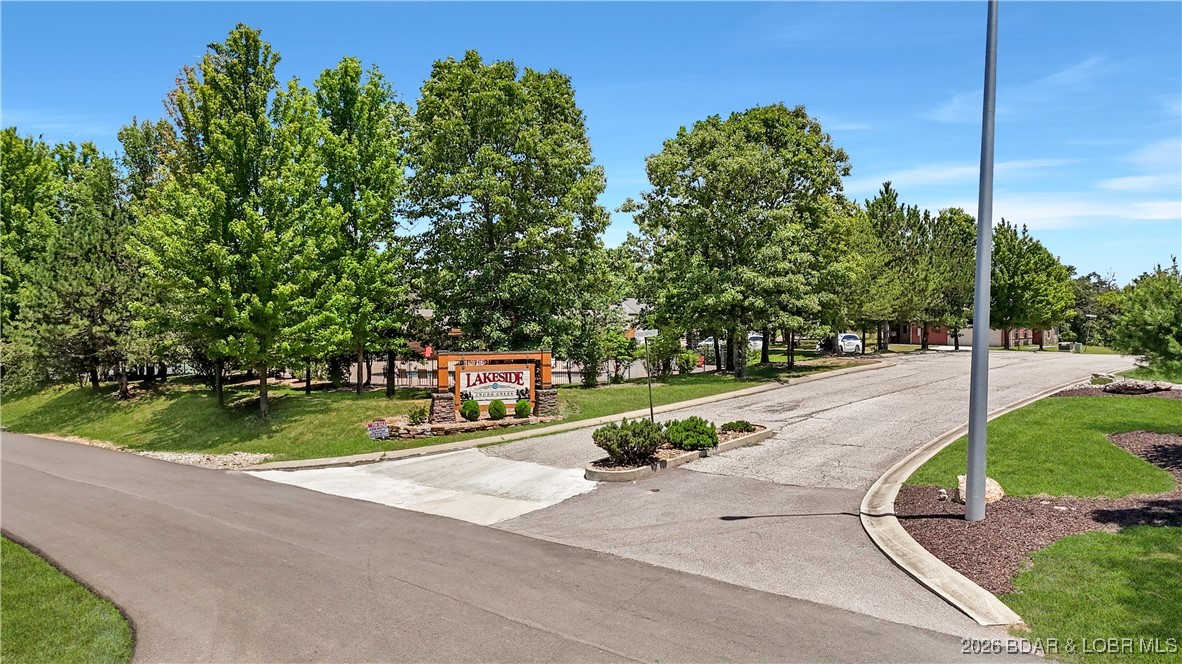 Welcome to Lakeside at Cross Creek, a premier gated community offering a rare opportunity to build in a peaceful yet highly convenient Lake of the Ozarks location. This buildable lot is surrounded by newer homes and quality construction, with access to shared amenities including a pool, tennis courts, and clubhouse. Sewer and well hookups are available, and builders are on hand to help bring your plans to life. Located between Camdenton and Osage Beach and within the Camdenton School District, this property offers both privacy and long-term value. Lot 4 Weathervane offers ~1.5 acres in a cul-de-sac with a lake view, but roughly 50 other lots are available as well!