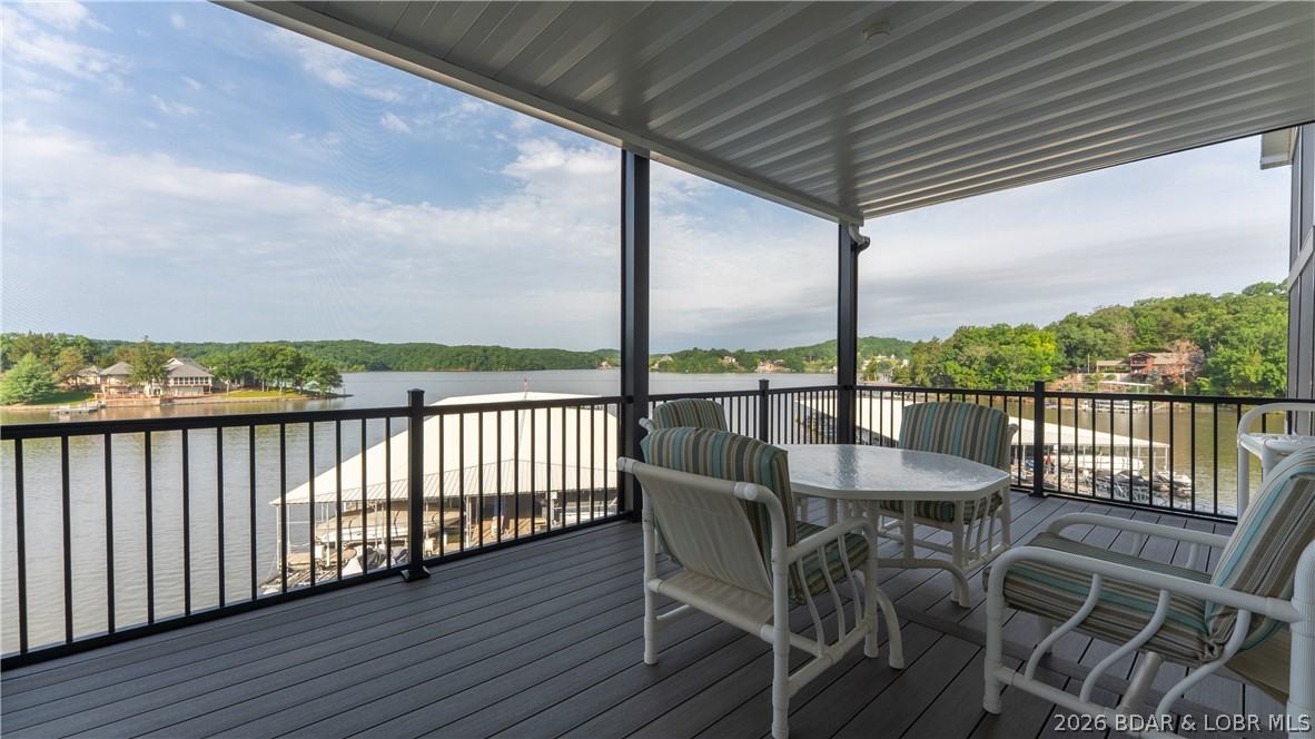 Nestled in a protected cove with beautiful main channel lake views, Keystone Village Condominiums offers a quiet setting, meticulously maintained grounds, a lakeside pool, and convenient access to everything Lake of the Ozarks has to offer. This spacious condo provides plenty of room for family and friends with each bedroom being a private suite. Whether you're looking for a full-time residence or the perfect lake getaway, you'll appreciate the functional layout and easy lakefront living this condo provides. Imagine yourself with that morning cup of coffee on the huge screened in porch or catching that perfect Lake sunset after a day of boating. Complete the package with the large 14x38 boat with easy access directly in front of your building.  With just 40 units, Keystone Village offers a more private and relaxed atmosphere than many larger condominium developments at the lake. Recent exterior improvements, including new decks, roofs, and stair towers, reflect the ongoing commitment to maintaining this exceptional complex.  This place is turnkey ready and dialed in.  Check it out today!