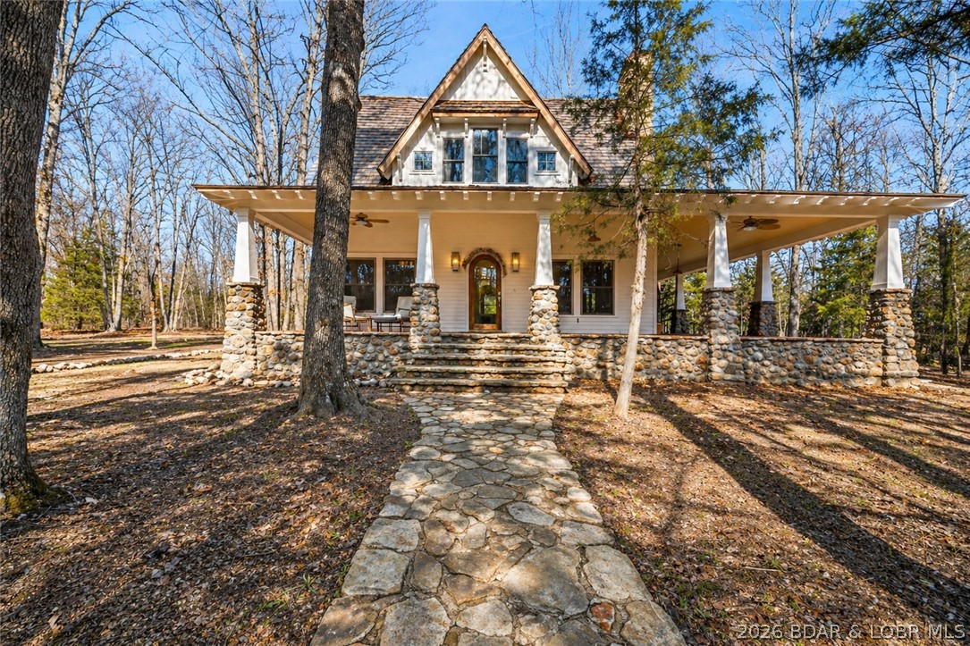 Step into a storybook setting where brand-new construction meets timeless cottage charm—this home feels straight out of a fairytale on 60 Acres.  Thoughtfully designed with timeless finishes throughout, this property captures cozy, whimsical living through custom cabinetry, vaulted ceilings, arched doorways, real hardwood floors, and a bright, open layout that feels elegant and inviting. The spa-like bathroom offers a walk-in tile shower and soaking tub, creating the perfect retreat. Three levels of living include a charming upstairs loft and an unfinished walk-out basement ready for your personal vision. Outside, a beautiful detached two-car garage with loft and its own porch adds both function and character. Enjoy peace of mind with Sherwin-Williams Emerald Rain Refresh paint with a lifetime warranty, LP SmartSide siding with a 50-year warranty, and a #1 cedar shake roof with a 40-year warranty. A stunning cedar wraparound porch frames serene sunrises and sunsets on private land provide excellent deer hunting and a private stocked pond. Ideal as a full-time home or dream vacation getaway.