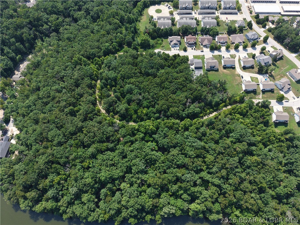 Rare opportunity to acquire 9.6± acres in the heart of Osage Beach, one of the few remaining large-scale development tracts within city limits. This highly desirable parcel offers exceptional development potential and is conveniently divided by an existing platted road easement, creating approximately 4 acres on one side and 5.7 acres on the other. The terrain is highly usable and well-suited for a variety of development possibilities, including apartments, townhomes, villas, condominiums, or residential communities.
Located just minutes from the Highway 54 Expressway via Parkwood Circle, this prime location offers easy access to shopping, dining, golf courses, entertainment, and all the conveniences Osage Beach has to offer. 
City water and city sewer are available at the property line, making this an outstanding investment and development opportunity in one of the Lake area's most sought-after markets.