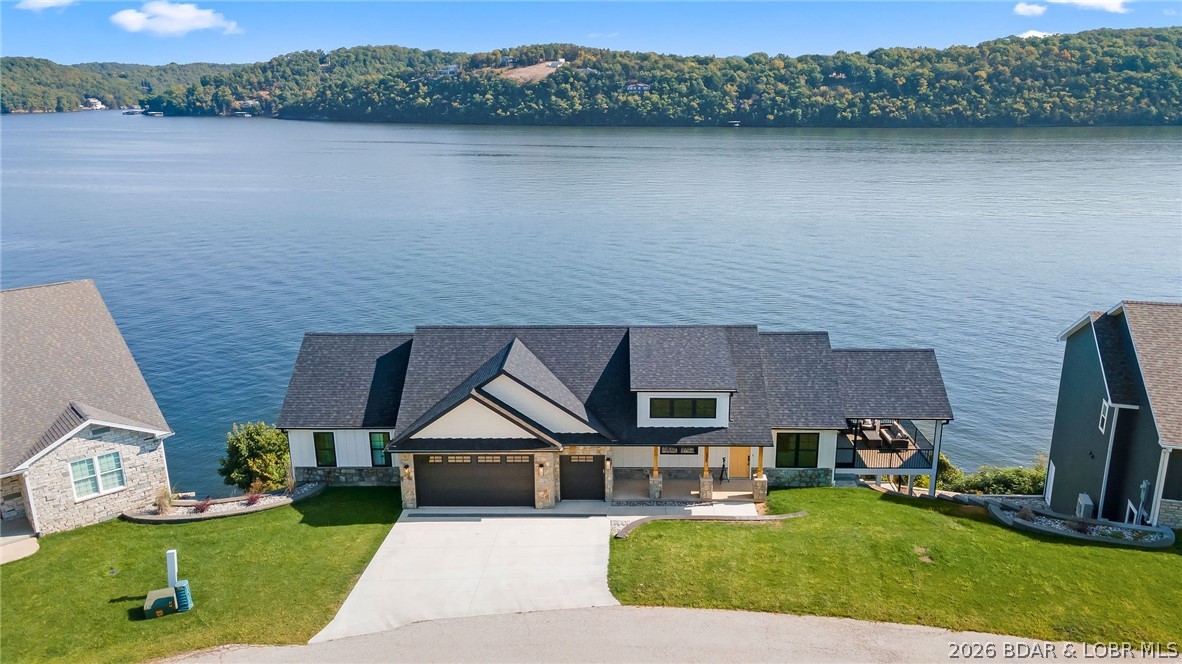 NEW CONSTRUCTION! Unobstructed lake views and luxury living await! This brand-new 4-bedroom home features two master suites, offering comfort and privacy for family or guests. Enjoy effortless entertaining with two spacious living rooms, a wet bar, and a coffee bar, all designed for modern lake living. Soak in the panoramic views from two expansive decks overlooking 136 feet of pristine lakefront, complete with a 14x40 boat slip just steps away. A 3-car garage and ample storage ensure space for all your lake toys. This is the perfect blend of style, space, and shoreline—a rare new construction opportunity you don’t want to miss!