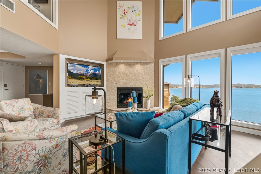 Seller willing to pay six months of condo HOA fees at closing with an acceptable offer. Take a look at this beautifully appointed 2-level, 3-bedroom, 3-bath condo offering breathtaking main channel views from the moment you walk in. Floor-to-ceiling windows perfectly frame the lake, filling the space with natural light, while professional tinting enhances energy efficiency without compromising the view. All lake-facing windows and three slider doors feature custom blinds, with select blinds battery operated for added convenience and a modern touch. This property is being sold fully furnished, making it truly move-in ready. Enjoy the lake lifestyle with a 12x40 boat slip and an additional PWC slip, both ideally located beyond the no-wake buoy for calm, protected water year-round. Located in The Breakers, a highly desirable community known for its quiet setting and no-rental policy, this condo offers peace and privacy. Amenities include a pool, clubhouse, and tennis courts. Convenient location by land or water with unforgettable views.