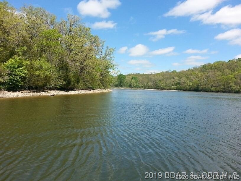 Hunters, and fisher paradise! 2,089' of gentle shoreline & 17.73 acres of beautifully diverse land. Held in the same family since 1952, over 74 years of history & presents a truly once-in-a-generation chance to own a large, private waterfront tract. A rare combination of acreage, shoreline, privacy, natural beauty—an opportunity that seldom becomes available at the Lake of the Ozarks. Outdoor enthusiasts will appreciate endless recreational opportunities, including fishing, kayaking, hunting,-exploring wide-open space. Property is rich with wildlife: deer, turkey, ducks. Eagles, making it a true haven for nature lovers. Previously operated as a cattle farm-enrolled in a forestry/crop protection program. Whether you envision a private estate, recr. getaway, hunting retreat, or legacy property, the possibilities here are truly endless. You will appreciate the endless recreational opportunities.  Shown by appointment after proof of funds. Seller must accompany all showings. Property is occupied-actively hunted— Do not access from Heather Rd or private driveway. Cameras/video security surveillance on property 24-7. Trustee for the trust is a licensed real estate agent.