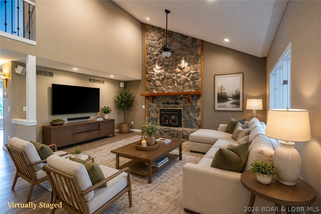 Exceptional value in one of the Lake's most sought-after neighborhoods - this spacious 4 bed/4 bath home offers over 3,300 s.f. yet feels even larger thanks to multiple living areas, generous room sizes, and a layout designed for gathering. The HUGE screened porch and seasonal lakeview create the perfect backdrop for relaxing or entertaining, while the oversized yard backs directly to the community pool, lighted tennis and pickleball courts, basketball court, playground, and firepit area—truly an ideal setup. Included is a boat slip w/hoist in the community dock, making lake days easy and convenient. The recently finished lower level adds even more flexible living space plus another full bath and oversized laundry area, perfect for a second family room, game room, bunk area, or man cave. Deep 2-car garage offers excellent storage for lake toys and golf carts. Buyers also love this neighborhood for its low HOA dues and golf-cart-friendly lifestyle with easy access to Dierbergs Markets, Ace Hardware, restaurants, and shopping. Priced BELOW recent appraised value for an exceptional opportunity so don't wait to take a look at this one!