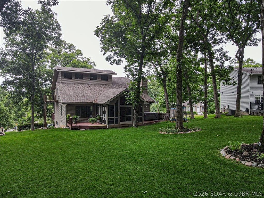 Exceptional value in one of the Lake's most sought-after neighborhoods - this spacious 4 bed/4 bath home offers over 3,300 s.f. yet feels even larger thanks to multiple living areas, generous room sizes, and a layout designed for gathering. The HUGE screened porch and seasonal lakeview create the perfect backdrop for relaxing or entertaining, while the oversized yard backs directly to the community pool, lighted tennis and pickleball courts, basketball court, playground, and firepit area—truly an ideal setup. Included is a boat slip w/hoist in the community dock, making lake days easy and convenient. The recently finished lower level adds even more flexible living space plus another full bath and oversized laundry area, perfect for a second family room, game room, bunk area, or man cave. Deep 2-car garage offers excellent storage for lake toys and golf carts. Buyers also love this neighborhood for its low HOA dues and golf-cart-friendly lifestyle with easy access to Dierbergs Markets, Ace Hardware, restaurants, and shopping. Priced BELOW recent appraised value for an exceptional opportunity so don't wait to take a look at this one!