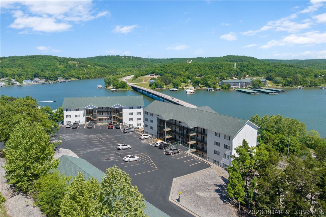 Experience lakefront living at its finest in this beautifully updated 3-bedroom, 2-bath condo overlooking the breathtaking Big Niangua at the 13-mile marker. Well maintained community with 3 pools!!! Perched perfectly for million-dollar views and direct lake access, this lower-level, fully handicap-accessible unit offers comfort, convenience, and style. Enjoy luxury vinyl plank flooring, tile finishes, and a spacious walk-in shower complete with grab bars. The open-concept layout flows seamlessly to outdoor living where you can take in panoramic water views. Included is a coveted 10x24 boat slip in the community dock, for fishing and boating.  A garage is available for extra $, perfect to store a golf cart or your lake toys. Handicap parking is conveniently located nearby, making access effortless. Whether you're looking for a full-time residence or the perfect lake getaway, this condo combines accessibility, luxury, and unbeatable lakefront living.