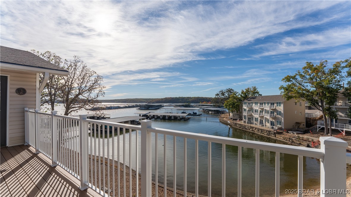 Turnkey lakefront living with strong rental appeal in the heart of Osage Beach. This top-floor 3BR/2BA condo feels like home the moment you walk in, with only a few steps from parking and one-level living once inside. Enjoy calm cove views from the living room, the primary suite, and a guest bedroom, plus vaulted ceilings and an open kitchen that keeps everyone connected.  Sold fully furnished, it’s ready to enjoy now or place into a short-term rental program right away. Big-ticket improvements are already done: HVAC 2022, new decking 2024, and new roof 2025 for lower-maintenance ownership.  Boaters will love the included 12x28 boat slip on a covered, newer concrete dock (an easy walk). The Seller uses the fireplace and has it checked often.  Kapilana Estates offers the amenities vacationers look for: clubhouse, pool, playground, and beach access with a quiet, family-friendly atmosphere and great walkability.  Best value in the complex as the lowest-priced 3BR/2BA currently available. Lake days start here.