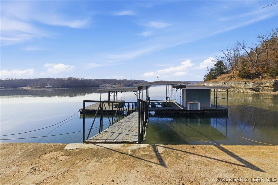 Get on the lake with this incredible 5.88-acre lakefront property offering over 300 feet of shoreline and stunning views. Enjoy a 54’ x 32’ dock with three boat wells, electric service, great water depth, and a storage shed ready to become the ultimate lakeside hangout. A 30’ x 40’ shop with concrete floors, three drive-in doors, and a roughed-in bathroom provides excellent flexibility—ideal for a shouse or future build support. Utilities include 50-amp service, wood stove venting, and AC accommodations. A 2019 Sportsman Toy Hauler currently sits on the prepared homesite with a rocked, well-maintained drive leading to the shop. Build now, enjoy the RV, or both—the choice is yours.  Don’t miss this rare lakefront opportunity—schedule your showing and step out onto the dock to take in the view.