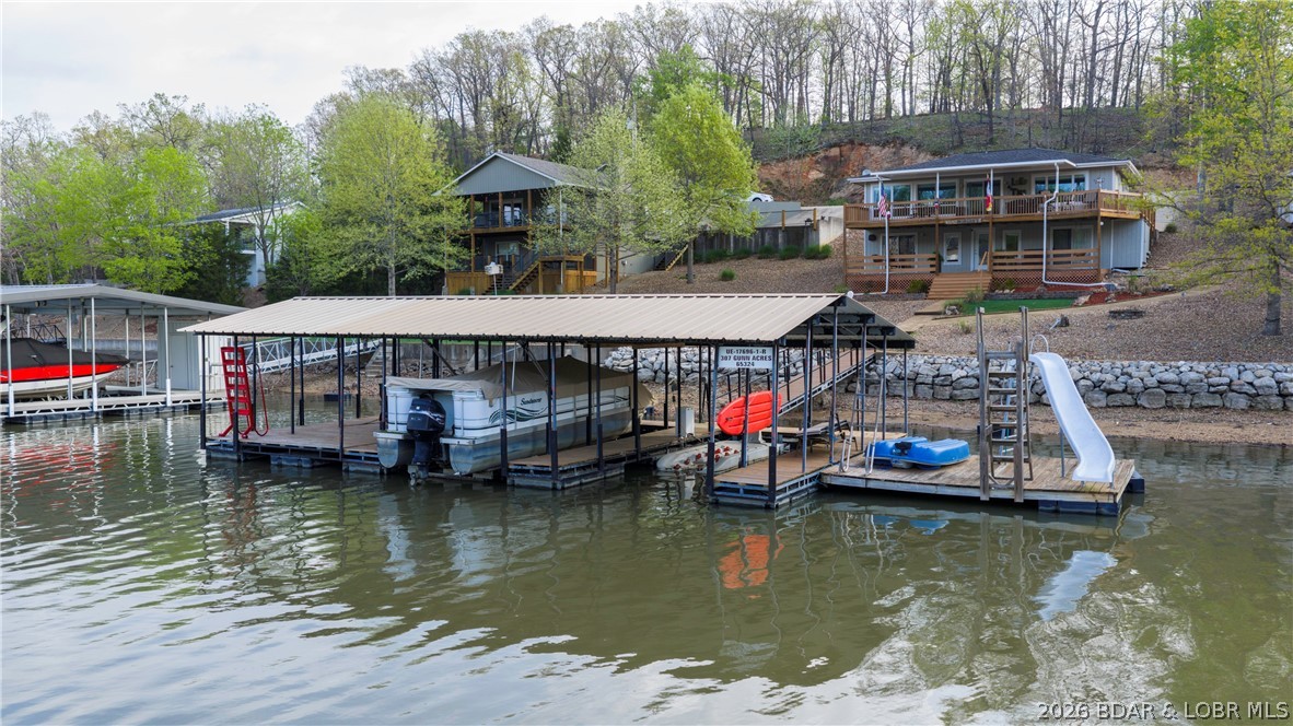 Lakefront living with investment potential at the 55 MM of the Osage Arm! This 2,240 sq ft home offers 4 bedrooms and 3 bathrooms, providing plenty of space for family, guests, or rental use. With 80 feet of shoreline, you’ll enjoy expansive lake views and direct access to the water. The property allows rentals, making it an excellent opportunity for both personal enjoyment and income potential. Recent updates add peace of mind, including a new roof (April 2026), HVAC system (2023), and septic system replacement (2022). The home is serviced by a private well and septic. Down at the water, a large dock features three 10x24 slips, a swim platform, boat hoist, and plenty of space to relax or entertain. A ski lift is negotiable. Whether you’re looking for a full-time residence, vacation getaway, or investment property, this lakefront home checks all the boxes. Schedule your showing today!