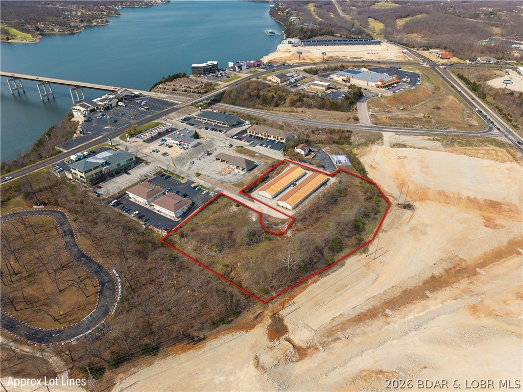 Prime investment opportunity with an established storage business in one of the most sought-after locations at the Lake. Ideally situated just off Business 54 and adjacent to Hwy 242. You won't find storage units for sale with the location, income, and room to grow like this. Designed with tenant convenience in mind, the facility features dual drive-through entrances—perfect for trucks and trailers with no need to turn around. The site sits on over 3 acres and is thoughtfully designed to complement surrounding professional buildings, enhancing its curb appeal and visibility. Currently offering 13,600 square feet of storage, the property includes engineered plans for significant expansion up to 46,200 square feet—creating incredible potential for increased revenue and long-term growth. 66 storage units that are 10x20 in size with 34 of those climate controlled options. Additional features include a spacious office with a large restroom, excellent signage visibility from busy Lake Ozark intersection with strong traffic exposure. Located just 1.6 miles from the proposed casino development, this property is positioned to benefit from future area growth. Call about this rare opportunity