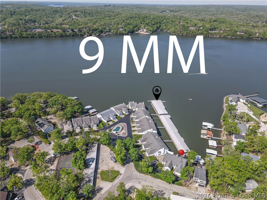 This luxury lakefront villa at The Palms is clearly designed for two families or hosting large family gatherings. Dual kitchens feature fully equipped with premium finishes including granite counter tops, custom cabinetry.  The upper level includes two pantries for maximum storage. Designed for convenience, the primary living area, dining room and kitchen are all located on main floor. Flowing directly onto an upper deck with views of the main channel.  Primary suite offers his & her closet, spacious bath with his & her sinks, tile walk in shower & jetted tub. The lower level mirrors the upper layout with its own kitchen, dining & living areas, which open to a screen in deck. Easy access to boat dock. Includes 16x48 slip and 12x36 slip.  Complex features a wave break & pool. Don't forget a 2 car attached garage.  Call to schedule a showing.