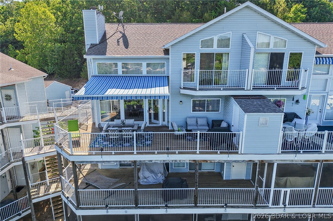 Welcome to Shores of Camelot in Libby Cove! This 2-bedroom condo with a loft, currently used as a third sleeping area, is located at the 2MM of the Niangua Arm. The top-floor location offers stunning lake views, soaring ceilings, and abundant natural light from a wall of windows. With 1,568 sq. ft., the open floor plan is ideal for everyday living and entertaining. The main level features a bedroom, full bath, laundry room, and spacious living area with fireplace that flows into the dining area and kitchen with stainless steel appliances, ample cabinet space, and bar seating. Upstairs are a second bedroom with balcony, full bath, and versatile loft. Enjoy the private deck with retractable awning and lake views. Includes furniture, storage closet, garage, and two boat slips with lifts, one with a Captain’s Call remote system. Community amenities include an inviting pool for your enjoyment and relaxation. Clean, furnished, turnkey, and ready for lake living!