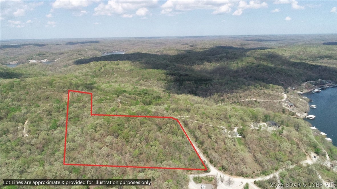 Experience the natural beauty of the Ozarks on this breathtaking approximately 9.5-acre parcel, offering a truly special setting for your future home or getaway. A gentle walk leads to a stunning knoll—an ideal building site—where you can take in peaceful surroundings and even enjoy winter glimpses of the lake and rolling hills. The land is rich with character, featuring unique grotto-style rock formations, rolling terrain, and some of the most striking white oak trees you’ll ever see. Tucked along a well-maintained road, this property offers both privacy and accessibility, creating the perfect balance for a serene retreat or long-term investment.
If you’ve been searching for one of the most beautiful acreage parcels the Ozarks has to offer, this one is truly unforgettable. Notice the very well maintained gravel road!  The road district is wonderful!  There is a $200 fee at closing and then $250 per year for road maintenance.  Taxes are estimated. Broker-owner.  Survey to determine exact parcel size. Lake lot plus additional acreage across the road is available to purchase.