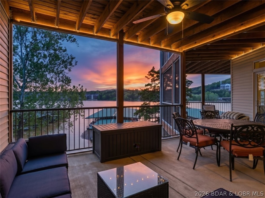 Experience effortless lake living at 55 Cedar Green #3E, this one-of-a-kind 4-bedroom, 3.5-bath lakefront condo in Cedar Green Luxury Condominiums. This thoughtfully designed condo complete with TWO -12x32 boat slips (PWC lift + lift) at Dock 3 and garage blends convenience and function. This open-concept floor plan highlights 9-foot ceilings and Great Room with dual sets of oversized sliding glass doors, seamlessly connecting the spaces to the expansive screened-in deck. The kitchen is both functional and inviting, complete with staggered cabinets, pantry storage, and breakfast bar. The dining area accommodates eight, making hosting effortless. The lakefront primary suite is a private retreat, offering water views and a luxurious bathroom with soaking tub, shower, and dual vanities. Oversized guest bedrooms provide exceptional comfort and space for visitors, while the additional half bath adds convenience and privacy. The showstopper is an oversized screened-in lakefront deck, perfectly positioned for sunset views over the water and lakeside pool. Conveniently located near golf, dining, recreation and shopping, this turn-key property delivers the ultimate lake experience.