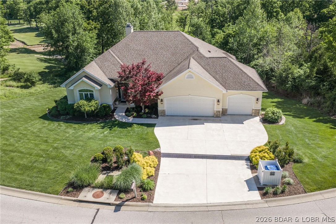 Golf course home with a Boat Slip? That's right this Custom built nearly 5,000sqft home is on the 12th green of The Cove golf course AND includes a 12x32(possibly 36) slip and 2 PWC slips in the community docks. This home has 4 bedrooms that are all en suites! Upon entering you're welcomed with a large entry that is off a formal dining/office area and looks through one of two living areas on main floor. The chefs kitchen is centrally located and well appointed including a gas range. The primary suite is sure to impress with his and hers closets, ambient heated bathroom floors, large open primary bathroom, and a second sitting area/office space. You'll love the large Covered concrete patio with gas hookups for your fire pit/grills. On the lower level you'll find 3 bedrooms all with thier own bathrooms, and another large living area and kitchenette. There's a storage room- previously used as a shop with built in cabinets, air filtration system and double doors leading outside. Through the lower living area you'll enjoy another concrete patio nearly the length of the house great for entertaining. Don't forget the 3 car garage and an irrigated lawn. This is the perfect package.