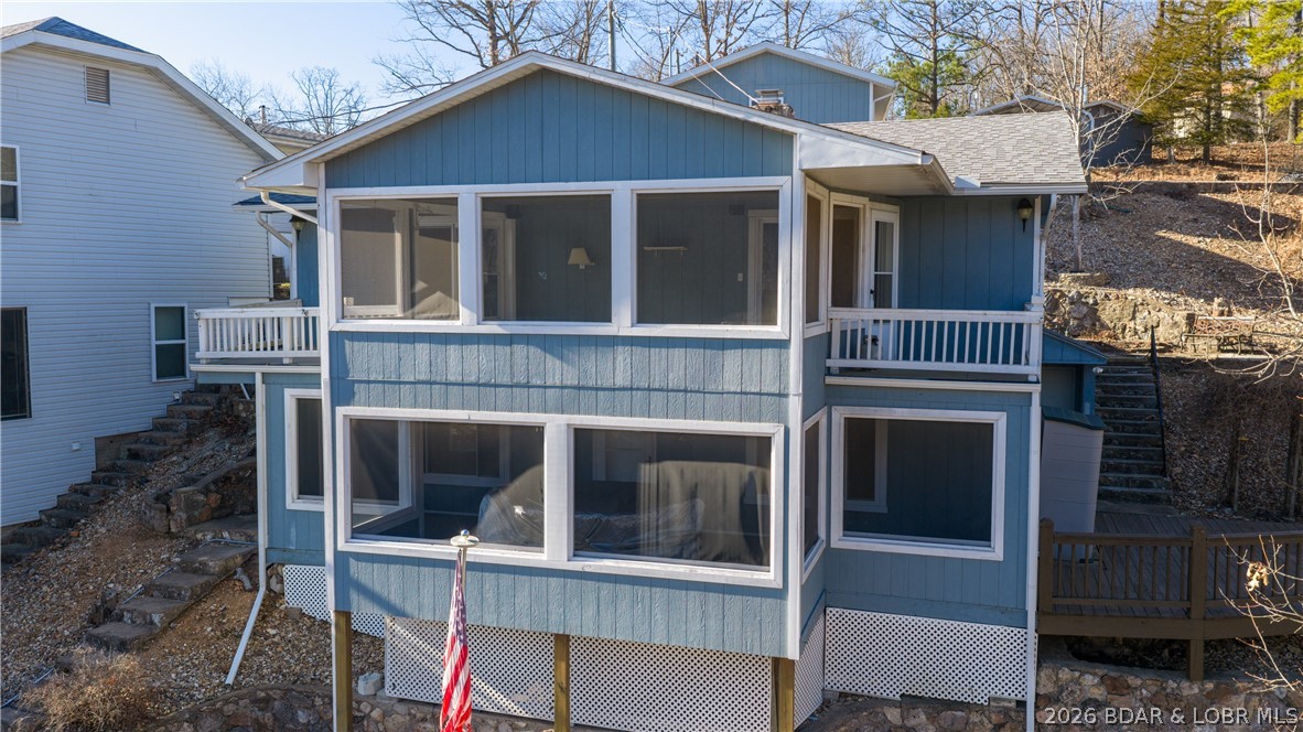 PRICE IMPROVED! The location on this 3 bed 2 bath home is hard to beat. 24mm by water with good depth of water in this cove. Short distance off of Route TT in Sunrise Beach. This lakefront home has been well cared for, with terrific updates in the kitchen and baths. The main floor living room walks out to a large screened deck, and the view is great towards the main channel. The main floor primary bedroom is huge with dual closets, and again a lakefront view. The lower level consists of a huge family room, 2 additional guest rooms, updated bath and a large utility/laundry room. The family room walks out to another large screened porch. Outside you'll find another area for gathering on the way to the 1 slip dock with attached swim platform and jet ski lift. On the roadside of the home is an oversized 1.5 car garage and additional carport. The homeowner just recently had new concrete walkway, steps and railings installed on the roadside of the home. This home is ready for the next owner.