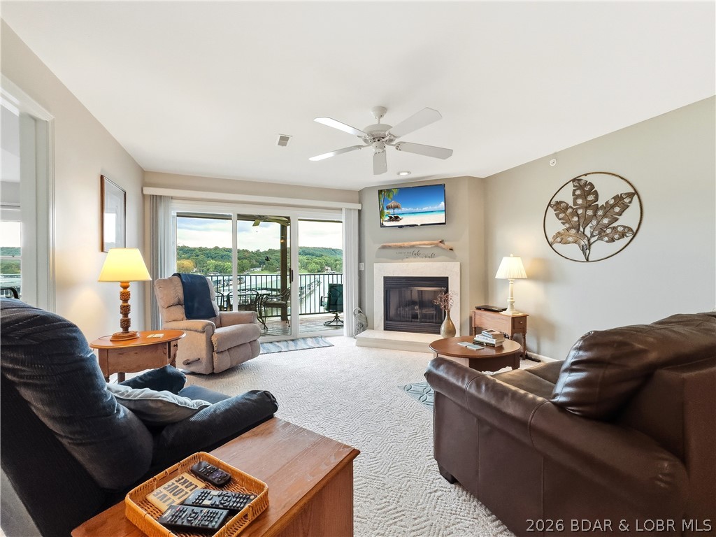 THIS ONE HAS IT ALL!  This well-appointed lakefront unit is a rare find since it comes complete with a 30 ft SLIP and a GARAGE!  If you are ready to start enjoying lake life, come take a look at this 2 bedroom 2 bath easy access unit. This unit is conveniently located near two top golf courses, a popular winery, restaurants, and Ha Ha Tonka State Park.  This popular complex boasts two heated pools, a playground for children, sand volleyball court, boat trailer parking, and abundant green space as well as a sense of community.  Fully furnished, this condo is ready and waiting for you. This unit can provide you a cozy retreat or even a permanent residence.  Step inside and let your cares slip away. This inviting unit is cozy and comfortable. You will enjoy preparing meals for family and friends in the bright cheery kitchen.  Relax with your morning coffee on This lakeside deck.  This unit offers a 12x30 foot slip with a 10,000# Fibersteel lift. A second slip is available for additional for $28,000 and a PWC is avaiable for $9500.  Don't miss out on an opportunity to have not only a 30 foot slip and also a garage.  Call for a showing today.