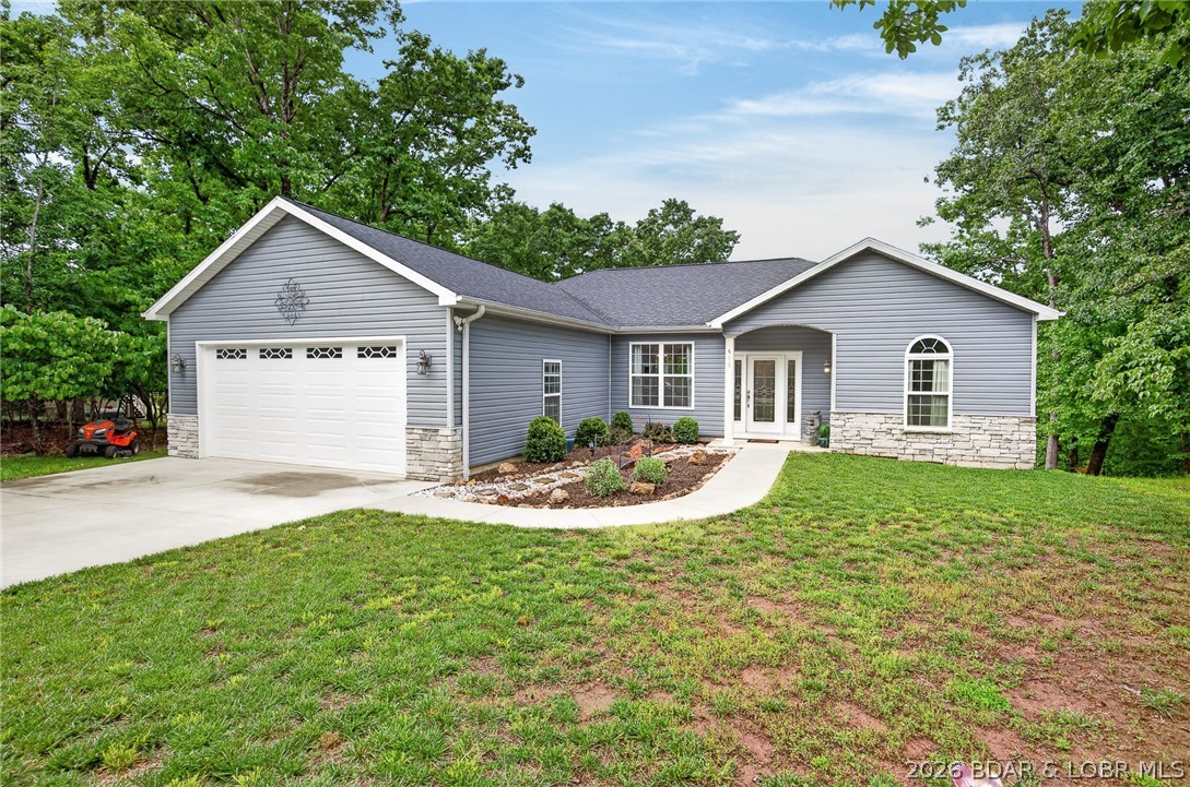 You need to come take a look at this beautiful custom built, three bedroom two bathroom home! As you enter, you'll quickly notice the quality furnishings with the stunning open concept perfect for entertaining,  spacious vaulted ceilings, modern electric fireplace, and abundance of custom cabinets with granite countertops and plenty of outlets.  There is ample room for meal prep with a beautiful 65 by 62 quartz top island with seating for six and even more cabinets.  Guests will love gathering around to visit.  And, when you think it can't get any better, step outside on the covered deck and enjoy the seasonal lake view in the sought after Cornett Branch Cove.  There is an extra 80 by 200 lot included for privacy that is great for bird watching in the surrounding tall trees. Need a little extra room to stow items, we have a well insulated walk in crawl space with a vapor barrier for extra storage.  And let's not forget our furrbabies, there is a fenced in area just for them. This home has it all in a beautiful neighborhood perfect for taking walks.  All this and The Four Seasons amenities!  https://fourseasonspoa.com/amenities/
