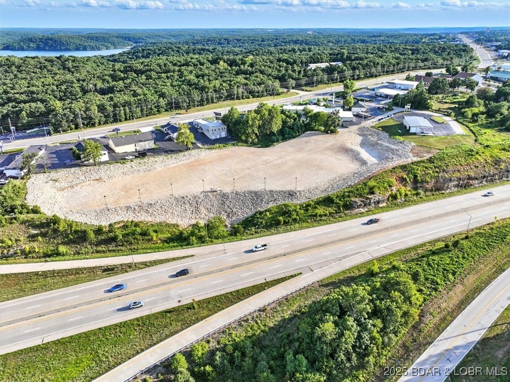Investors and developers, take notice! This approximate 4.40-acre commercial-zoned property offers an exceptional opportunity in one of the fastest-growing corridors in the region. With an impressive approximate 738 feet of Highway 54 frontage, your project will benefit from maximum exposure and accessibility. Located just one exit from the upcoming Oasis Amusement Park and the 400-room Marriott Hotel, and near the future Bass Pro Shops, this site is primed for high-traffic success. The area is rapidly transforming into a major destination, making this the perfect time to secure your stake. Limitless development potential—ideal for a hotel, business park, shopping center, medical facility, or sports complex. Infrastructure and momentum are already in motion—don’t miss your chance to be part of the next big thing in Osage Beach.