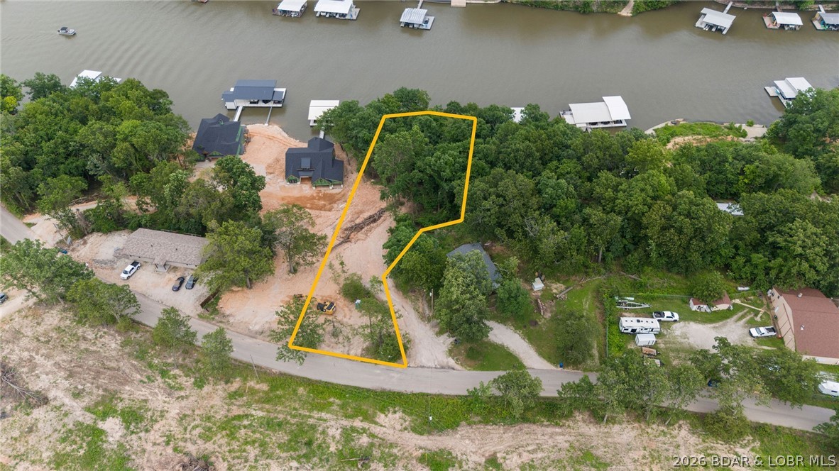 Discover the perfect setting for your custom luxury lakefront retreat in this exciting new upscale subdivision. This prime residential homesite offers 107 feet of shoreline, stunning main channel views, and the ideal combination of open-water scenery with cove protection . Build the luxury lake home you've always envisioned with ample space to create your dream design. Enjoy the freedom and flexibility of NO HOA, allowing you to make the most of your investment. A rare opportunity to own a premier waterfront lot in one of the area's newest luxury developments. Call for a private showing today !